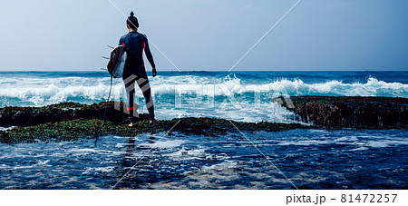 Woman surfer with surfboard going to surf on seaside Woman surfer with surfboard going to surf on seaside 81472257