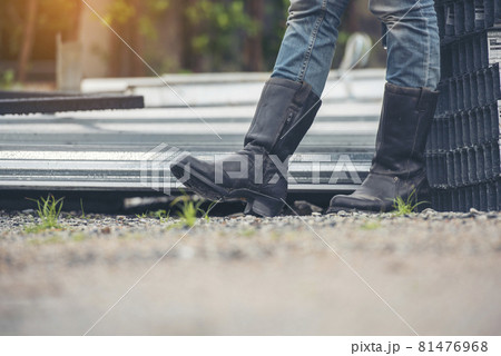 Women wear construction Boots safety footwear for worker at construction site. Woman Engineer Wear Jeans black Boots Worker standing at construction site. Engineer safety industry footwear walking Women wear construction Boots safety footwear for worker at construction site. Woman Engineer Wear Jeans black Boots Worker standing at construction site. Engineer safety industry footwear walking 81476968