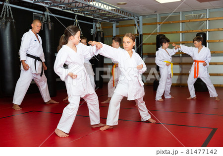 Kids sparring during karate training Kids sparring during karate training 81477142