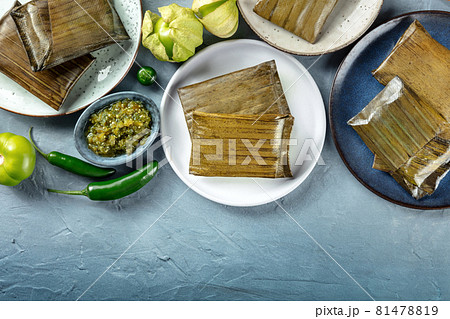 Tamale, traditional dish of the cuisine of Mexico, wrapped in green leaves Tamale, traditional dish of the cuisine of Mexico, wrapped in green leaves 81478819