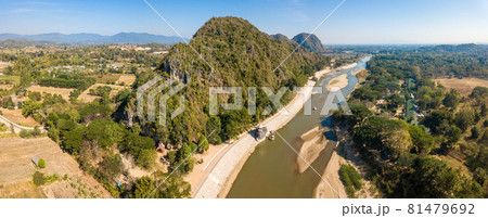 Aerial view of the mountain landscape with Kok river a river flowing out of the hills of Burma's Shan State winding its way across Chiang Rai province to Mekong river. Panorama view from drone. Aerial view of the mountain landscape with Kok river a river flowing out of the hills of Burma's Shan State winding its way across Chiang Rai province to Mekong river. Panorama view from drone. 81479692