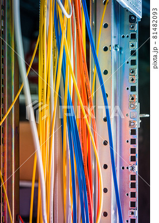 Detail of server room with bunch of fiber optic cables at the ba 81482093