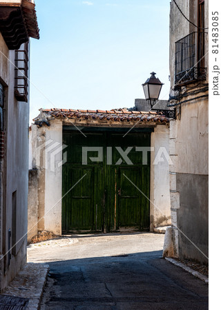 Green painted wooden doorway in the historic center of a village 81483085