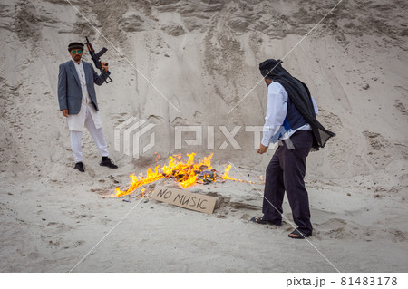 Afghan terrorists destroy music with fire. 81483178