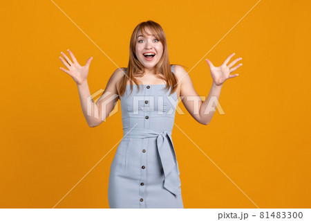 Happy, joyful young beautiful girl isolated on yellow studio background. Concept of human emotions, facial expression, youth, sales, ad. 81483300