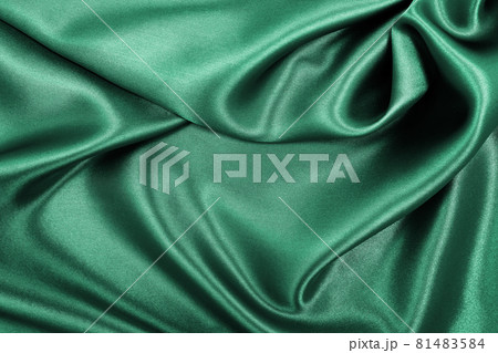 Smooth elegant green silk or satin luxury cloth texture as abstract background. Luxurious background design Smooth elegant green silk or satin luxury cloth texture as abstract background. Luxurious background design 81483584