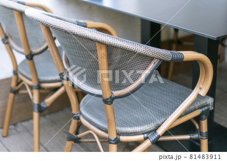 Comfortable wicker chair in a cafe close-up. Selective focus. Empty table in the cafeteria Comfortable wicker chair in a cafe close-up. Selective focus. Empty table in the cafeteria 81483911