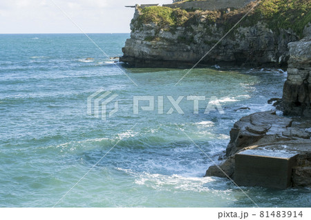 Beautiful calm waves crashing against the rocks of the coast of the picturesque bay of the island 81483914