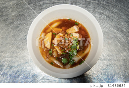 Chinese roll noodle soup with Crispy pork, Boiled egg, Pork blood Served on white bowl. Thai language called (Kuay Jab). Chinese roll noodle soup with Crispy pork, Boiled egg, Pork blood Served on white bowl. Thai language called (Kuay Jab). 81486685