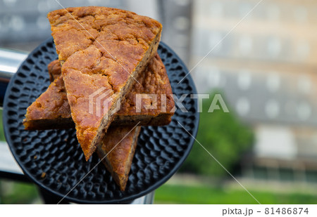 Homemade tasty banana cake slices on Black ceramic plate with city view. Homemade tasty banana cake slices on Black ceramic plate with city view. 81486874