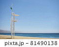 aid station on a beach with calm sea on sunny day and green flag 81490138