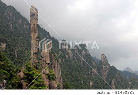 Sanqingshan Mountain in Jiangxi Province, China. View of Snake Rock or Python Rock, a rocky pinnacle on Mount Sanqing. Sanqingshan is a sacred Taoist mountain famous for its misty peaks and forests. Sanqingshan Mountain in Jiangxi Province, China. View of Snake Rock or Python Rock, a rocky pinnacle on Mount Sanqing. Sanqingshan is a sacred Taoist mountain famous for its misty peaks and forests. 81490835
