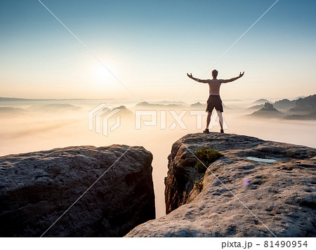 Happy trail runner at rocky view edge raised arms to sun greeting. Happy trail runner at rocky view edge raised arms to sun greeting. 81490954