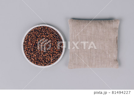 Grape seeds pillow, grape pits filled pillow for spa massage - natural heat or cool pack. Alternative medicine and therapy, pit sack for chiropractic care and home health. Copy space and mockup Grape seeds pillow, grape pits filled pillow for spa massage - natural heat or cool pack. Alternative medicine and therapy, pit sack for chiropractic care and home health. Copy space and mockup 81494227