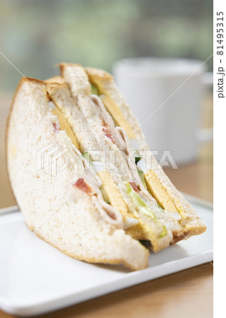 美味しいソーセージと玉子と野菜の全粒粉サンドイッチとコーヒー 81495315