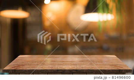 Empty wooden table top with lights bokeh on blur restaurant background Empty wooden table top with lights bokeh on blur restaurant background 81496600