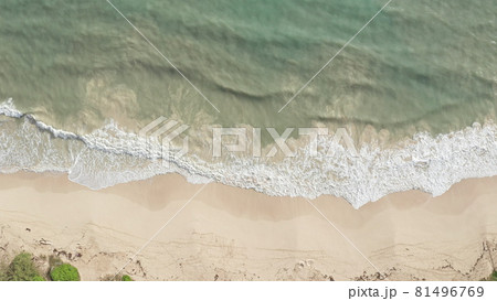 Aerial view from above down Drone shot. Beautiful tropical beach sea with white sand. Top view. Empty and clean beach in summer season on Oahu Hawaii Island. Aerial view from above down Drone shot. Beautiful tropical beach sea with white sand. Top view. Empty and clean beach in summer season on Oahu Hawaii Island. 81496769