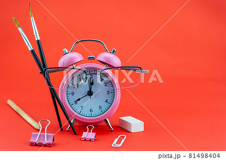 Concept Education or business Alarm clock and teacher glasses Business objects isolated on colorful background Back to school concept 81498404