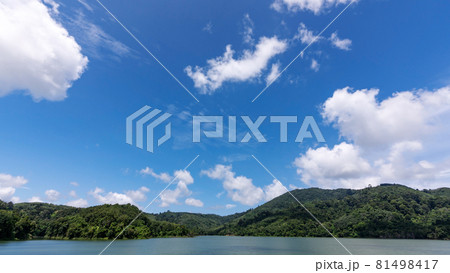 White clouds in blue sky over green mountains covered with rainforests trees Beautiful landscape of Mountain and Lake with reflex in the water scenery beautiful view with blue sky and white clouds. 81498417