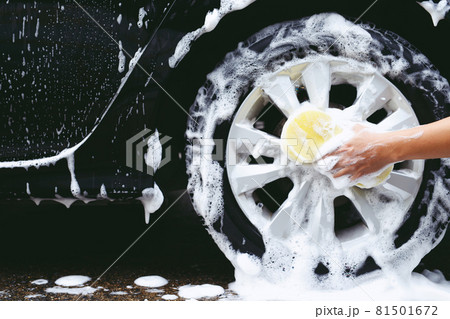 people man holding hand yellow sponge for washing car. cleaning wheel tire. Concept car wash clean. people man holding hand yellow sponge for washing car. cleaning wheel tire. Concept car wash clean. 81501672