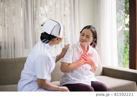Senior asian woman having chest pain suffering from heart attack,Nurse take care and support Senior asian woman having chest pain suffering from heart attack,Nurse take care and support 81502221