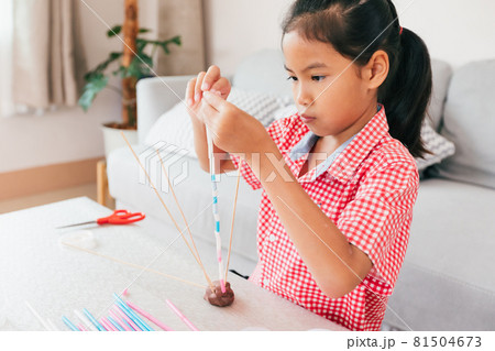 Cute asian child girl playing and creating with playdough and straws. Child concentrated with playdough building a molecule model. Kid and craft with recycle things. Cute asian child girl playing and creating with playdough and straws. Child concentrated with playdough building a molecule model. Kid and craft with recycle things. 81504673