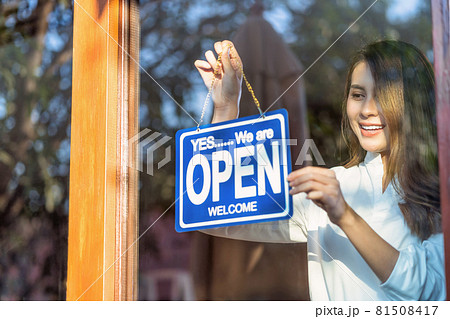 Asian young asian woman setting open sign at the shop glasses for welcome the customer in to the coffee shop, small business owner and startup with cafe shop, installing open and close label concept 81508417