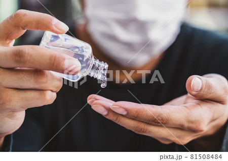 Closeup Asian man doing hand sanitizer pumping alcohol gel before working with technology laptop, Working from home in Covid-19 pandemic, social distance and responsibility concept 81508484