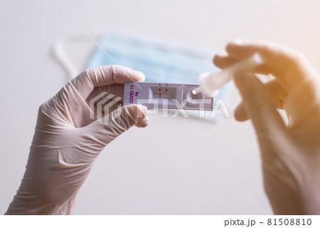 Patient women hands showing result a covid-19 self test rapid antigen testing at home Patient women hands showing result a covid-19 self test rapid antigen testing at home 81508810