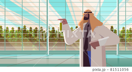 agricultural engineer holding test tube with chemicals arab man farmer researching plants in greenhouse 81511056