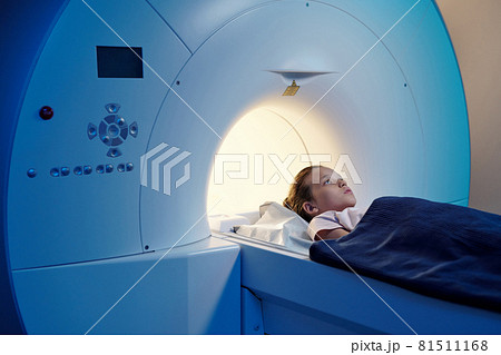 Little patient under blue towel lying on long table of mri scan machine Little patient under blue towel lying on long table of mri scan machine 81511168
