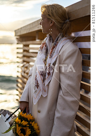 Top view elegant blonde woman contemplating sea waves from sand beach relaxing at luxury resort 81511266
