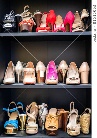 Gray closet shelves full of fashion female shoes on heels pair storage organization of cupboard 81515063