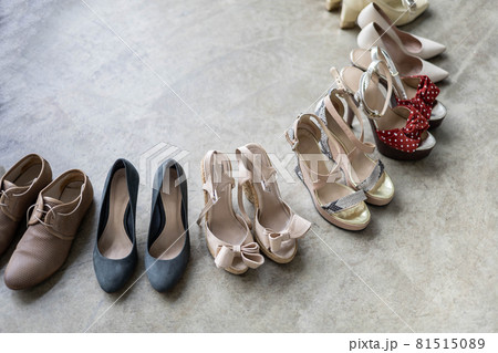 Top view many colored female shoes on gray floor footwear wheel fashion stylish footgear choosing 81515089