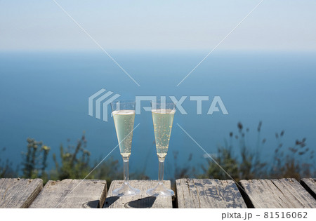 Champagne glasses by the blue sea Champagne glasses by the blue sea 81516062