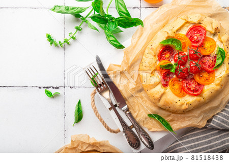 Fresh homemade galette with tomatoes, ricotta cheese and basil Fresh homemade galette with tomatoes, ricotta cheese and basil 81518438