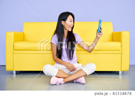 Smiling asian woman making video call by cell phone talking with friends or family 81518678