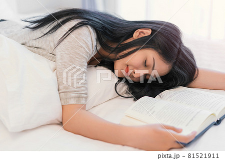 Young beautiful woman sleeping on book she read after hard working day tired, Sweet dreams, education, reading for examination, favourite literature, busy day concept 81521911