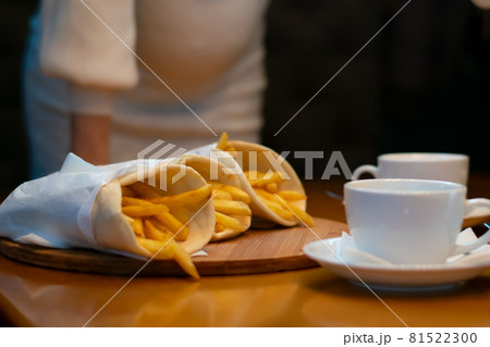 french fries are lying on the background of a pregnant girl 81522300