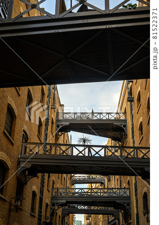 Shad Thames in London, UK. Historic Shad Thames is an old cobbled street known for it's restored overhead bridges and walkways. This old street is in Bermondsey near Tower Bridge and London Bridge. 81522371