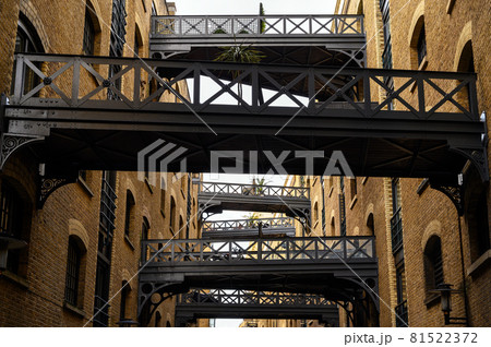 Shad Thames in London, UK. Historic Shad Thames is an old cobbled street known for it's restored overhead bridges and walkways. This old street is in Bermondsey near Tower Bridge and London Bridge. 81522372