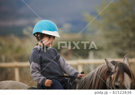 5-year-old girl riding a horse. infalltil sport concept 5-year-old girl riding a horse. infalltil sport concept 81522636