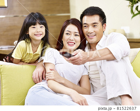 asian parents and daughter watching TV at home asian parents and daughter watching TV at home 81522637