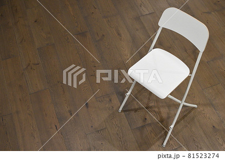 White wooden chair with a back on the floor in the room 81523274