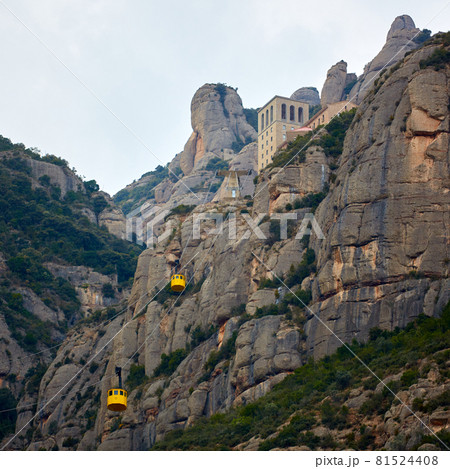 Yellow cable car in the Aeri de Montserrat rise to de Montserrat Abbey near Barcelona, Spain, Catalonia. Yellow cable car in the Aeri de Montserrat rise to de Montserrat Abbey near Barcelona, Spain, Catalonia. 81524408
