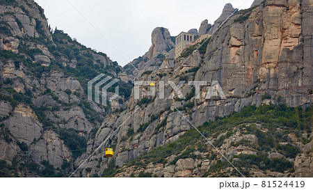 Yellow cable car in the Aeri de Montserrat rise to de Montserrat Abbey near Barcelona, Spain, Catalonia. Yellow cable car in the Aeri de Montserrat rise to de Montserrat Abbey near Barcelona, Spain, Catalonia. 81524419