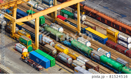 Barcelona, Spain - April 8, 2019: Aerial view on industrial port Mare Combinato Sl. Trucks, load, railway station. Barcelona, Spain - April 8, 2019: Aerial view on industrial port Mare Combinato Sl. Trucks, load, railway station. 81524516