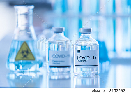 Bottle of COVOD-19 vaccine sample in a laboratory with lab equipment in blur background. Idea for researching and lab tests for coronavirus curing Bottle of COVOD-19 vaccine sample in a laboratory with lab equipment in blur background. Idea for researching and lab tests for coronavirus curing 81525924