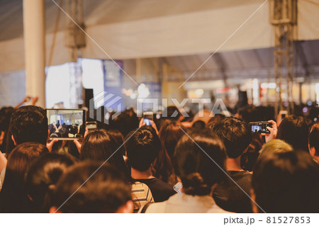 nightlife and youth activity with backside of crowd in concert hall during show hand ,take photo and see  their favorite artist 81527853