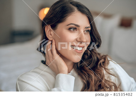 Pretty young long-haired woman in a white blouse Pretty young long-haired woman in a white blouse 81535402